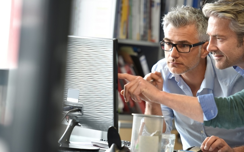 Two men working in office