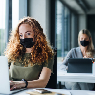 Women in office wearing facemasks