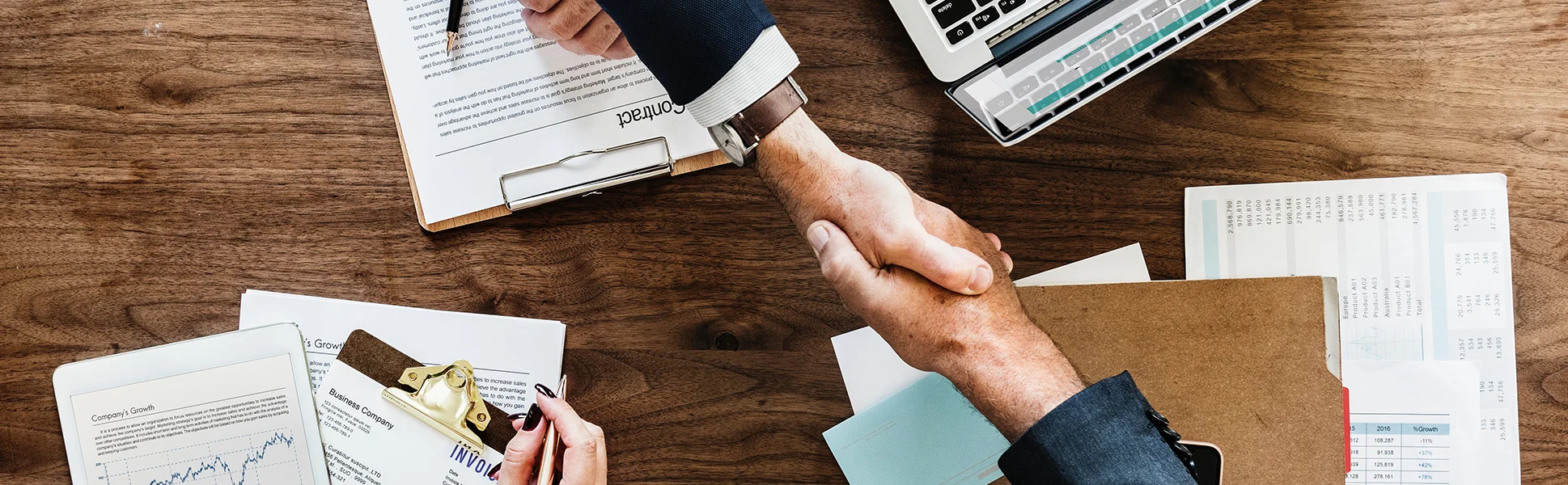 Handshake across a table