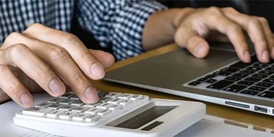 Person entering figures into a calculator